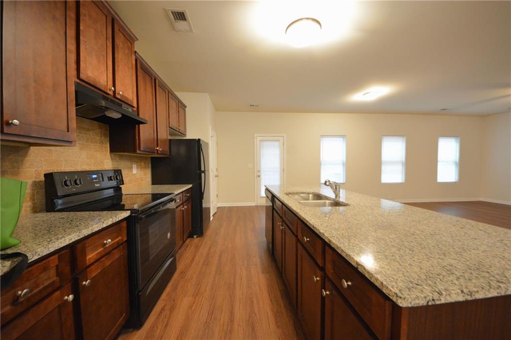 4305 Traipse Path Ellenwood, GA 30294 - Photo 17 of 36 a kitchen with stainless steel appliances granite countertop counter space a sink and cabinets