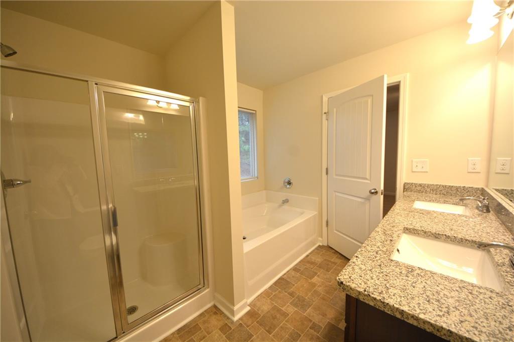 4305 Traipse Path Ellenwood, GA 30294 - Photo 27 of 36 a bathroom with a granite countertop shower and a sink