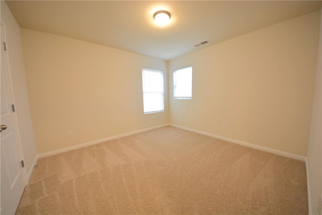 4305 Traipse Path Ellenwood, GA 30294 - Photo 35 of 36 an empty room with windows