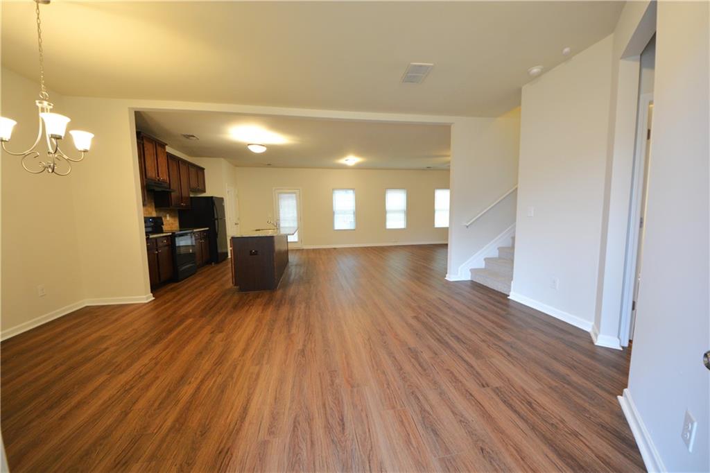 4305 Traipse Path Ellenwood, GA 30294 - Photo 8 of 36 a view of a living room with wooden floor and a kitchen