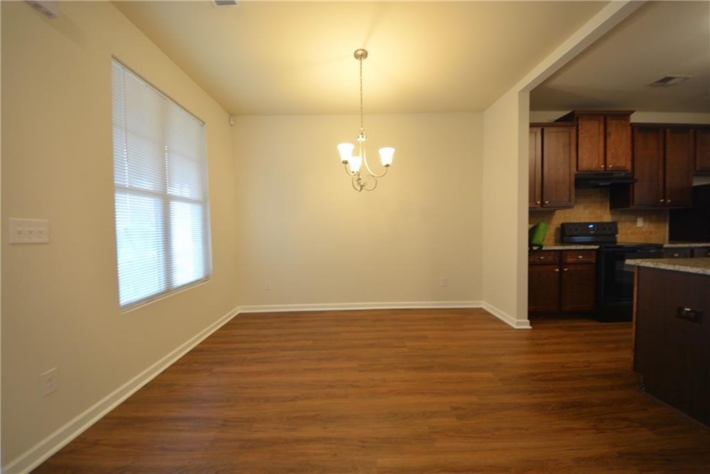 4305 Traipse Path Ellenwood, GA 30294 - Photo 9 of 36 a view of a kitchen with wooden floor and a sink