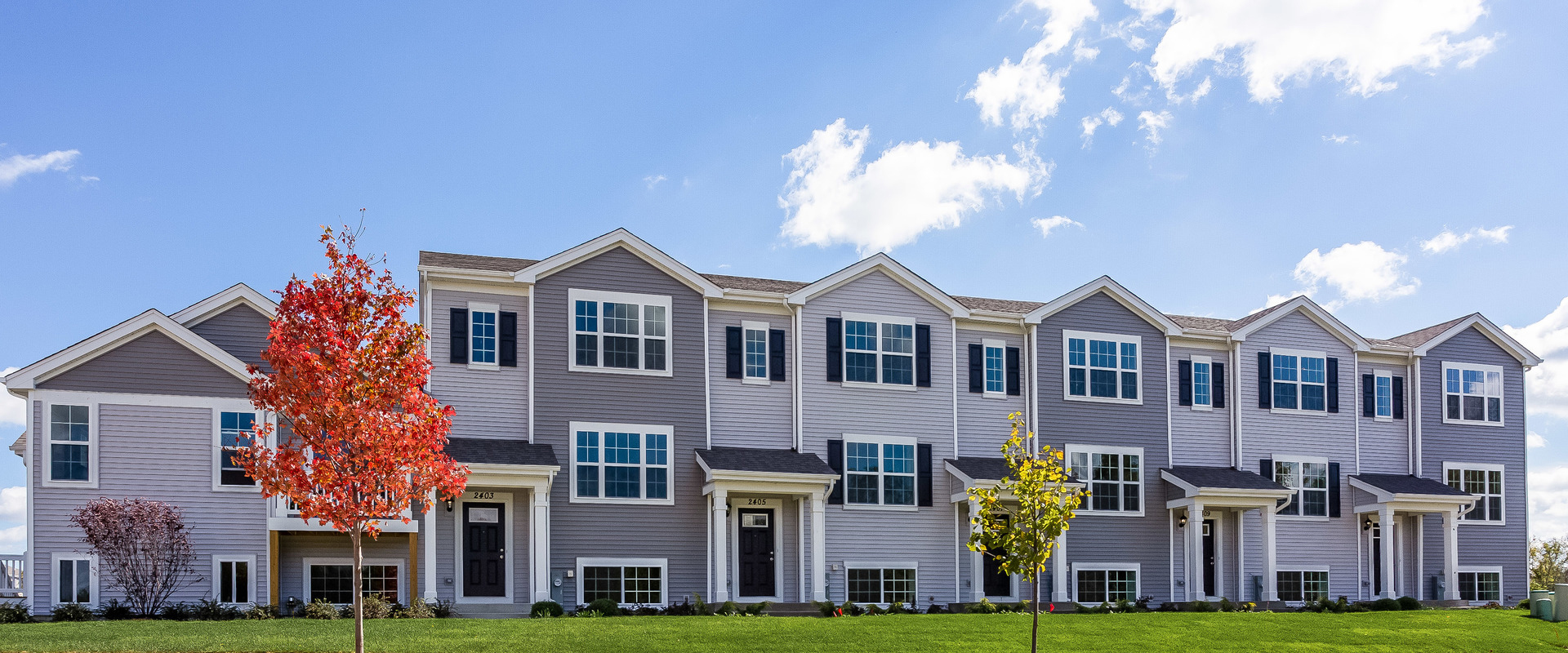 2407 Upland Road Pingree Grove, IL 60140 - Photo 1 of 19 a front view of a residential apartment building with a yard