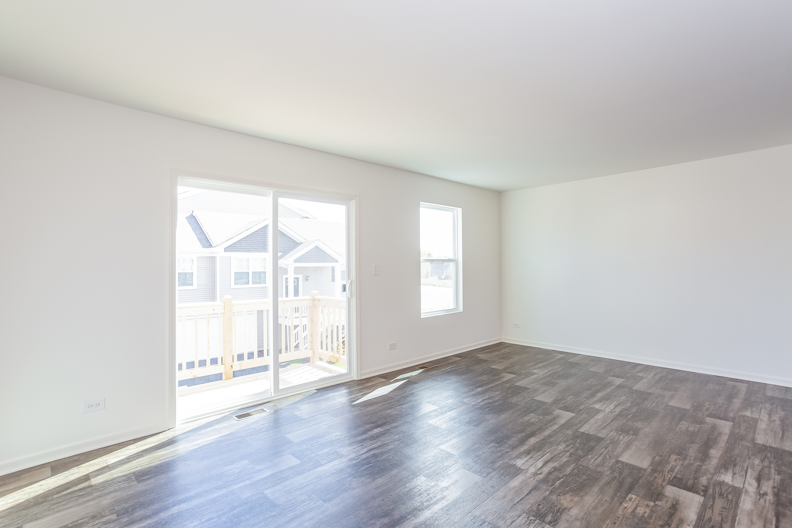 2407 Upland Road Pingree Grove, IL 60140 - Photo 6 of 19 an empty room with wooden floor and windows