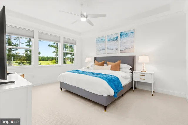 a bedroom with a bed and a dresser next to a window