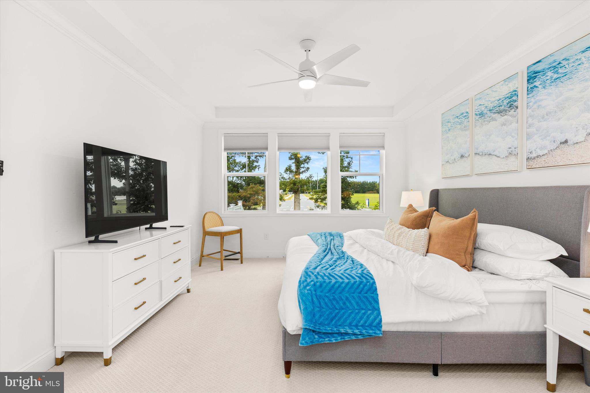 19277 American Holly Road Rehoboth Beach, DE 19971 - Photo 12 of 28 a bedroom with a bed and a flat screen tv