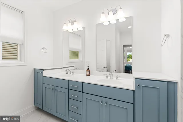 a bathroom with a double vanity sink and a mirror