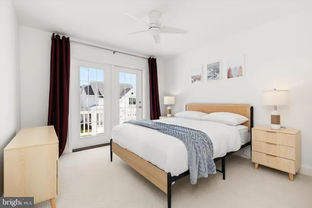 a spacious bedroom with a bed and a lamp