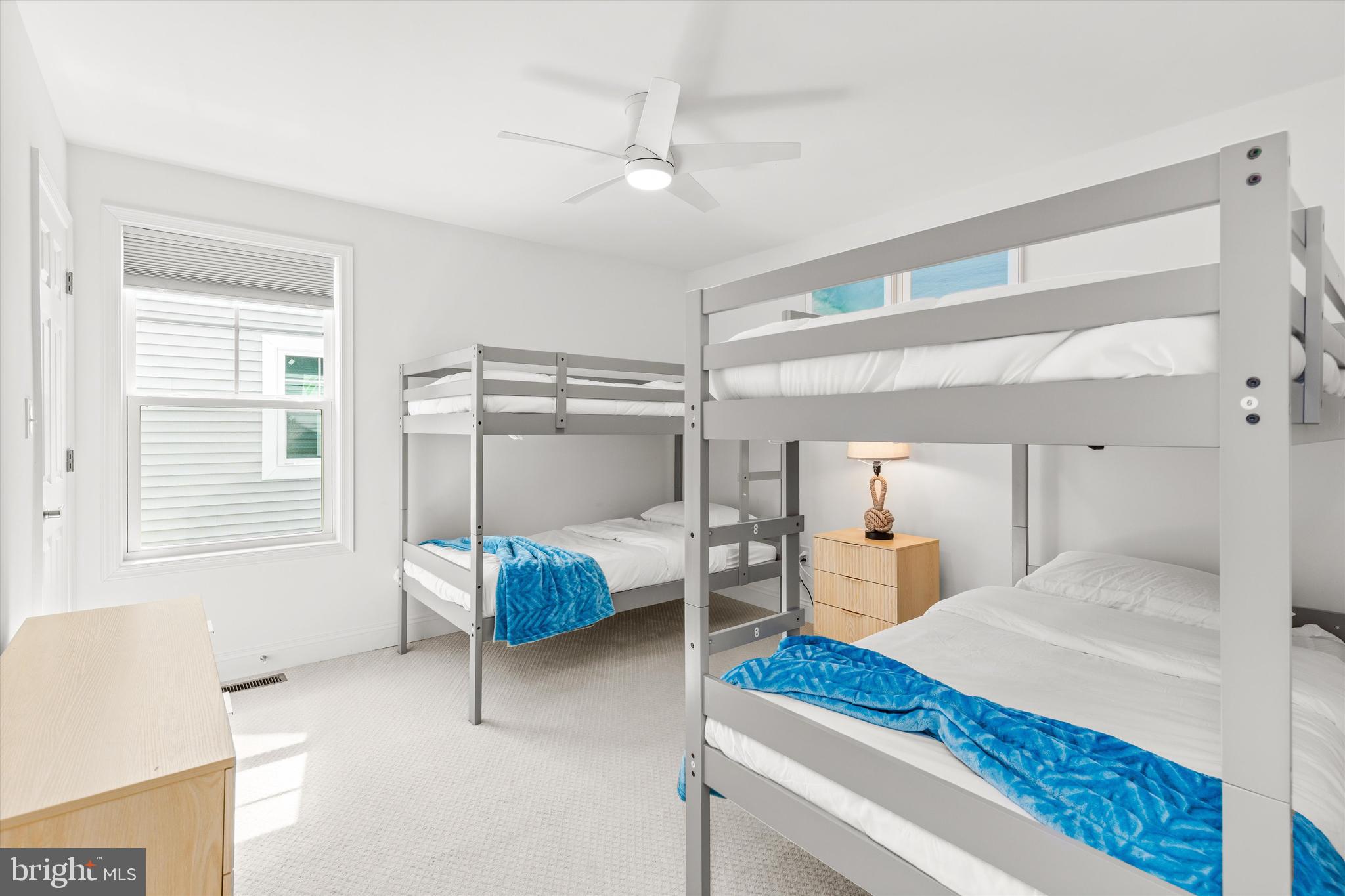 19277 American Holly Road Rehoboth Beach, DE 19971 - Photo 15 of 28 a bedroom with a bed and a window