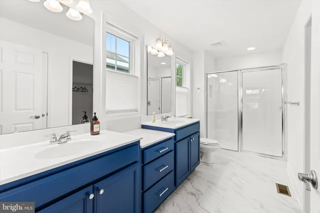 a bathroom with a double vanity sink mirror and double