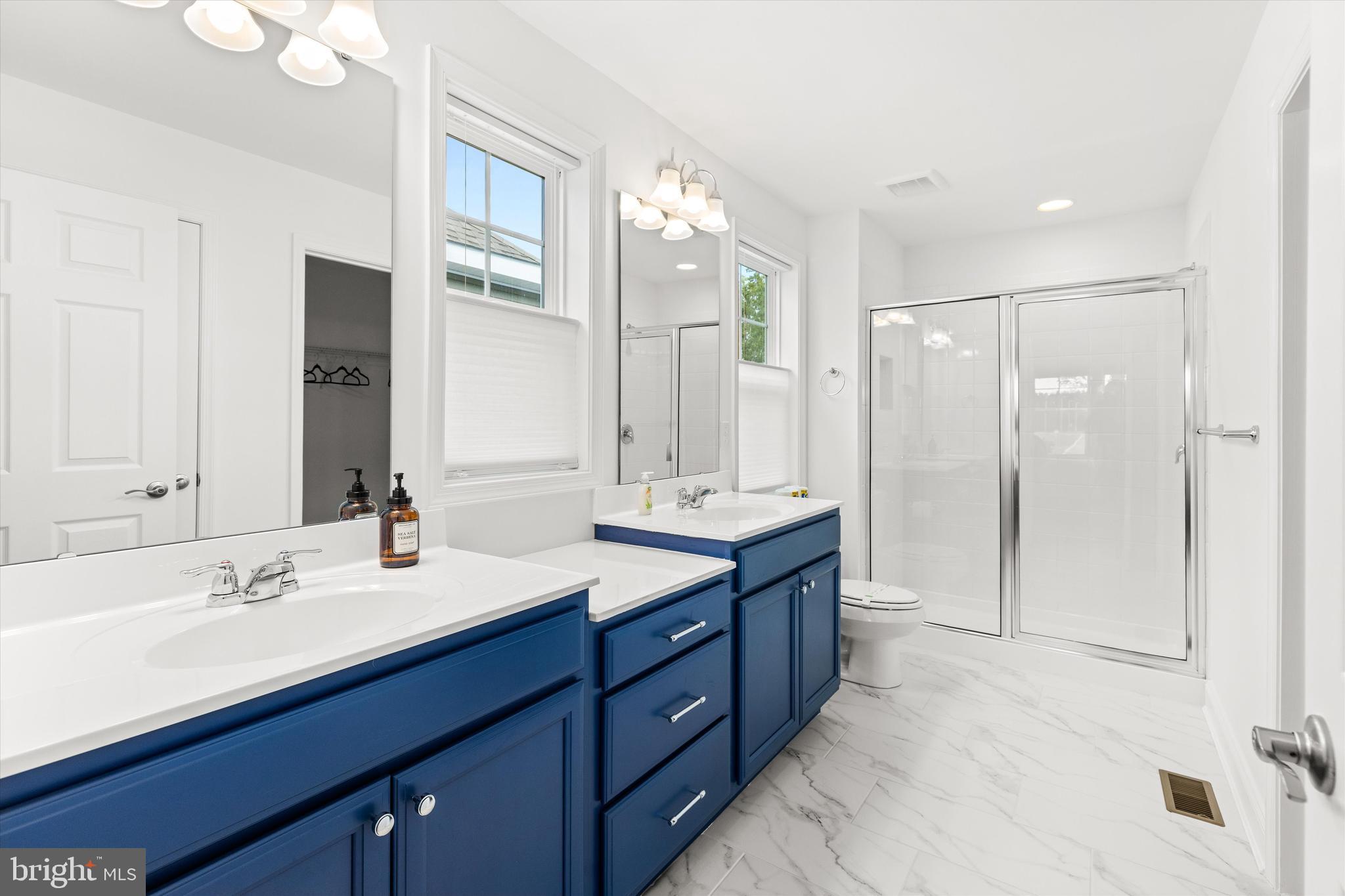 19277 American Holly Road Rehoboth Beach, DE 19971 - Photo 20 of 28 a bathroom with a double vanity sink mirror and double