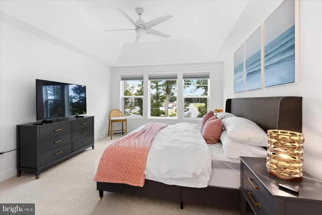 a bed room with a bed window and dresser