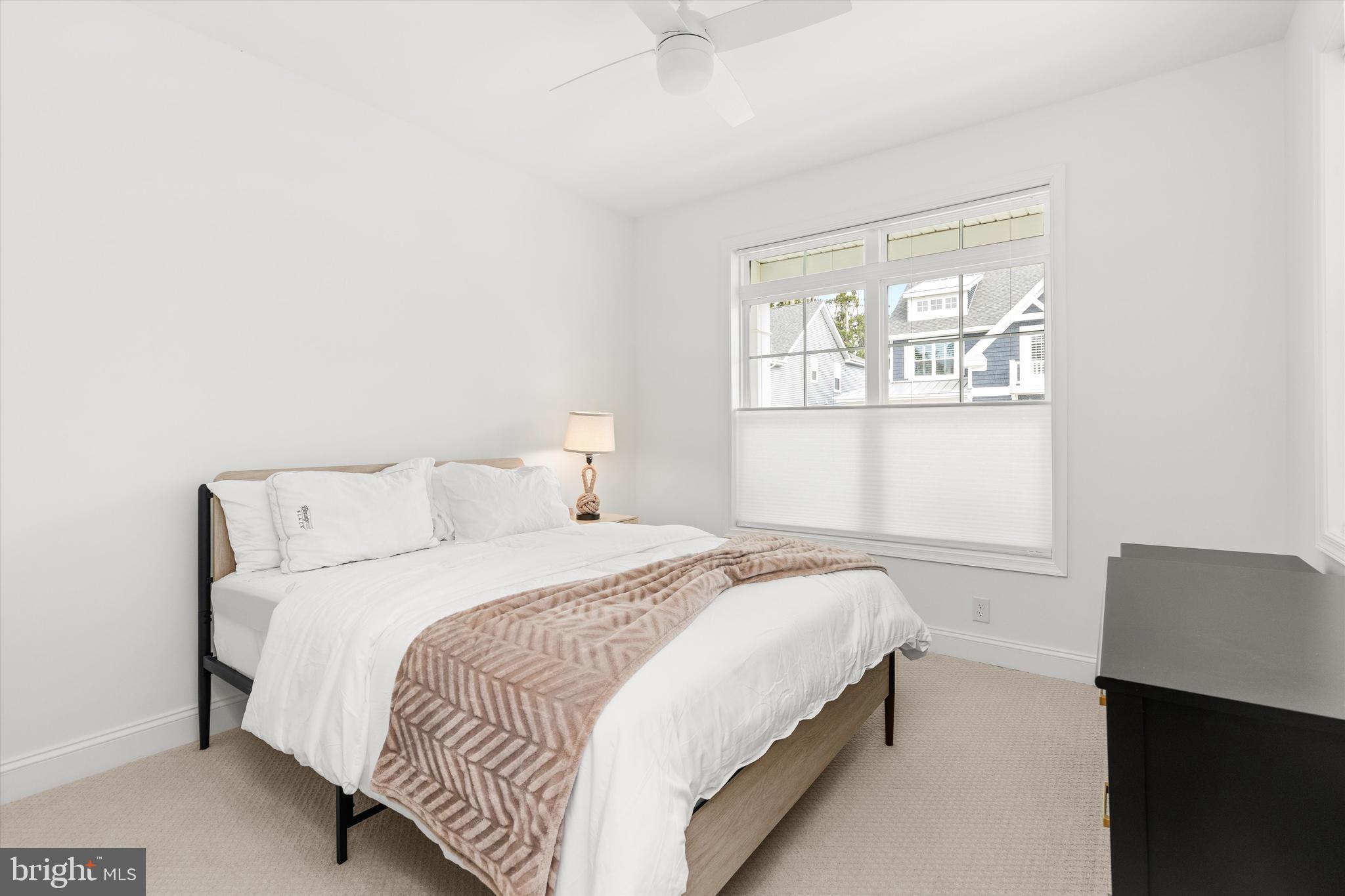 19277 American Holly Road Rehoboth Beach, DE 19971 - Photo 23 of 28 a bedroom with a bed and a window