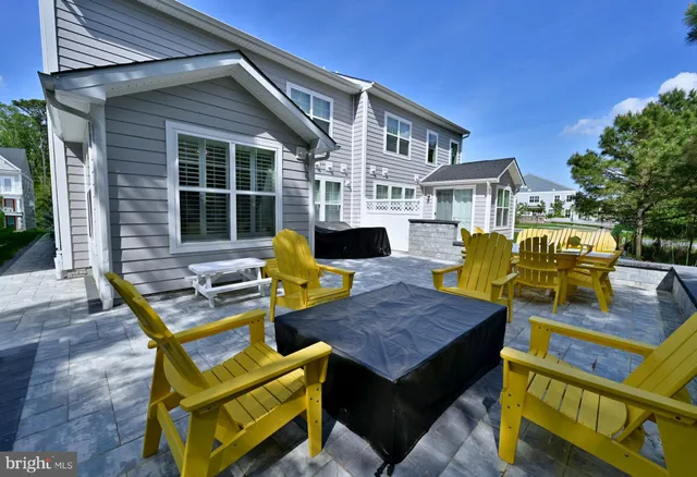 a view of a house with swimming pool and sitting area