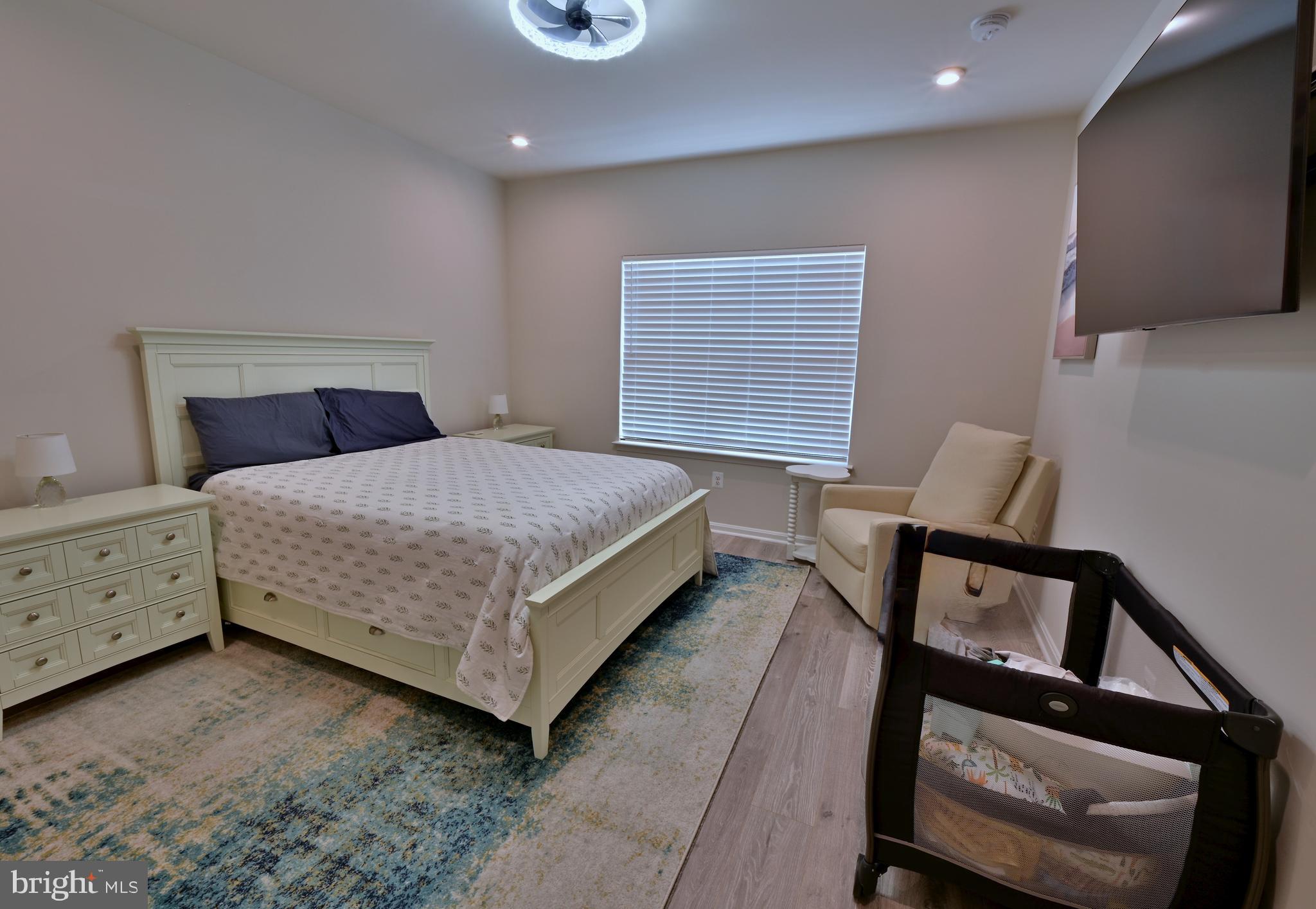 19277 American Holly Road Rehoboth Beach, DE 19971 - Photo 27 of 28 a bedroom with a bed and a dresser