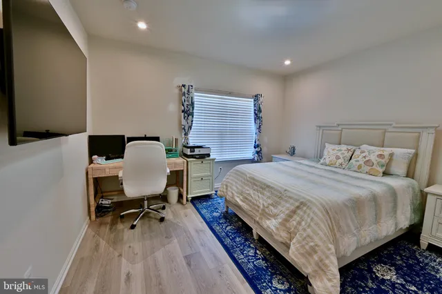 a bedroom with a bed and a desk