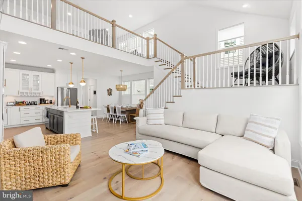 a living room with furniture and kitchen view