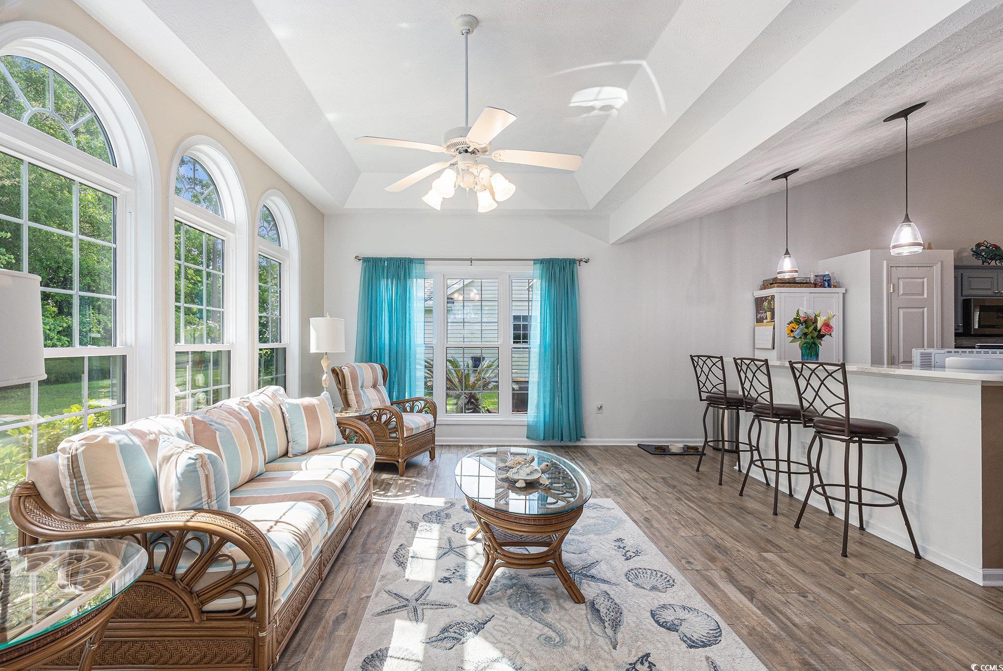 1105 Lampwick Lane Murrells Inlet, SC 29576 - Photo 16 of 40 Living room featuring wood finished floors, ceiling fan, vaulted ceiling, and baseboards