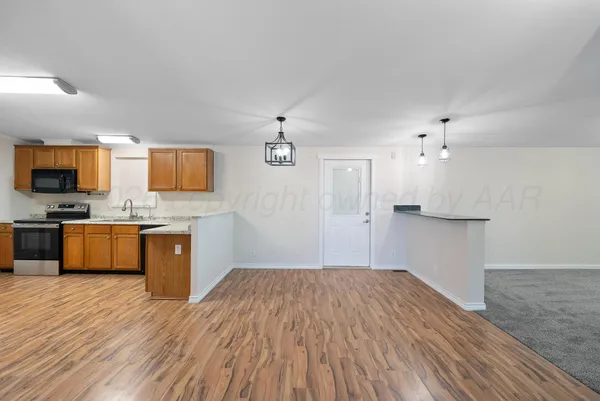 a view of a kitchen with a sink and refrigerator