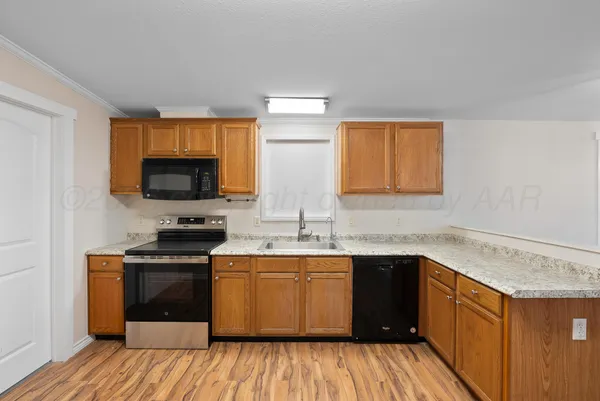 an empty room with a fireplace and a chandelier fan