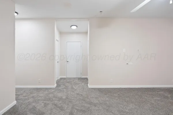 a view of empty room with wooden walls