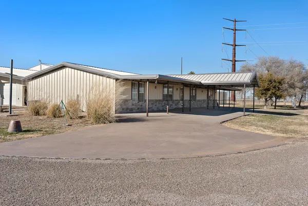 a view of a yard with a house and large trees