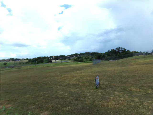 a view of a lake with houses in back