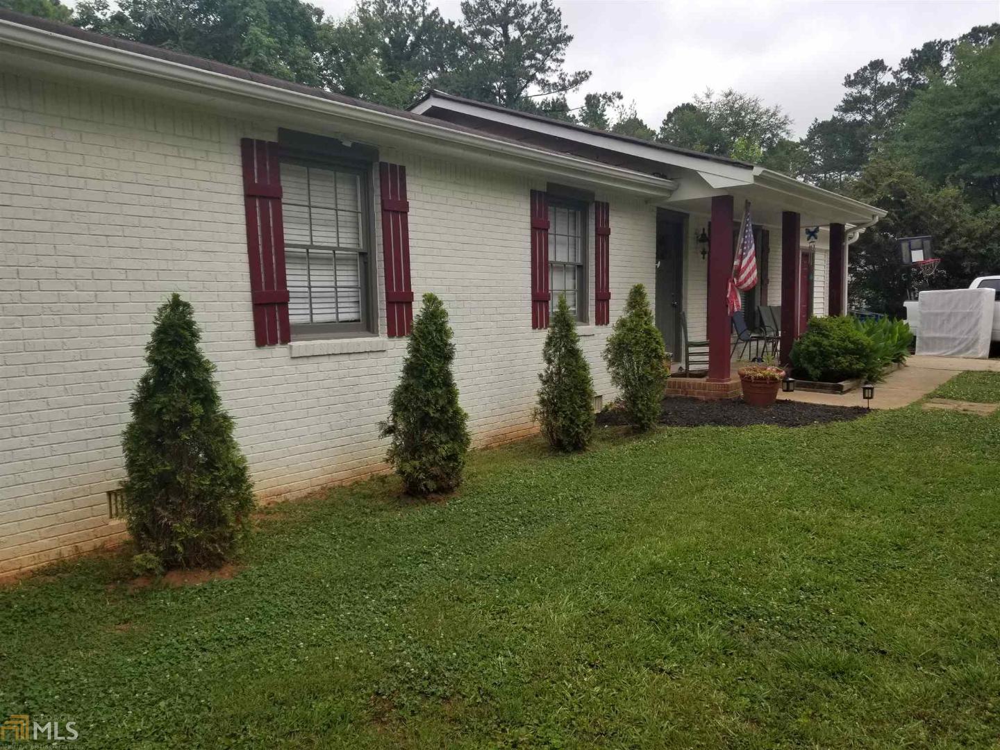 3123 Goode Road Conyers, GA 30094 - Photo 1 of 1 a front view of a house with garden