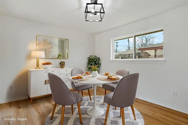 a view of a dining room with furniture window and wooden floor