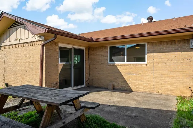 a view of a house with backyard and wooden deck