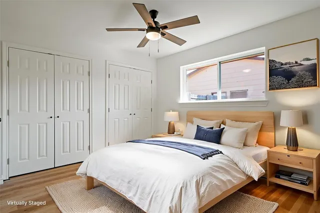 a bedroom with a bed and a painting on the wall