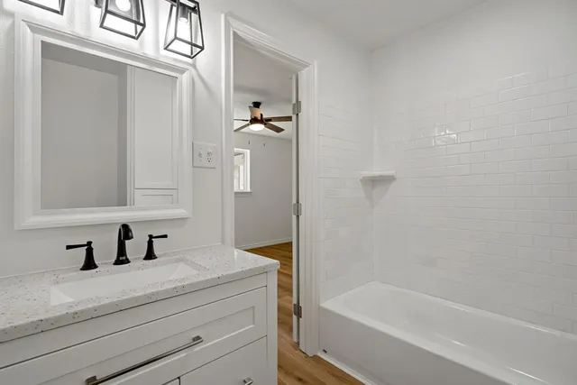 a bathroom with a bathtub and a sink