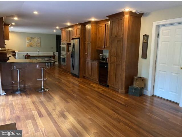 a living room with furniture a fireplace and large windows