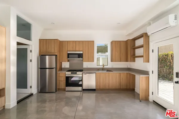 a large kitchen with cabinets and stainless steel appliances