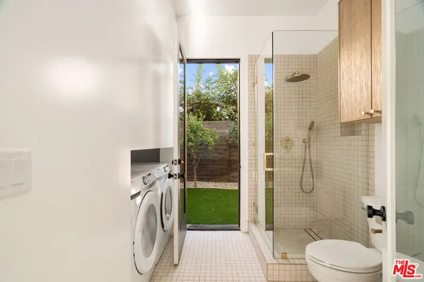 a bathroom with a shower a toilet and shower