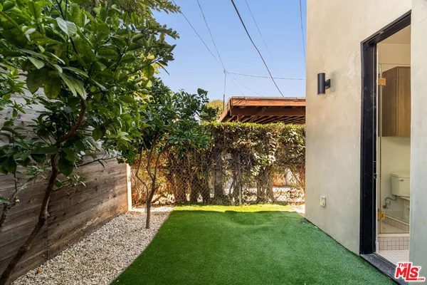 a view of a backyard with potted plants