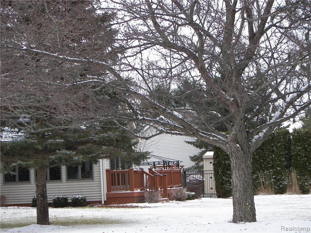 6788 Kestrel Ridge Road Brighton, MI 48116 - Photo 17 of 18 Side view of home. Many mature trees.