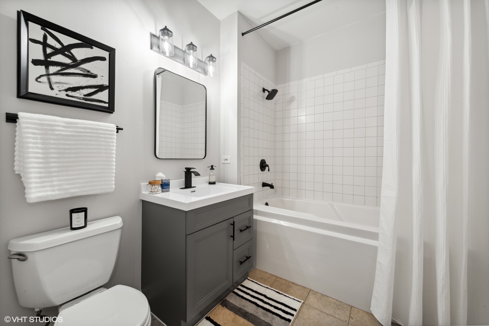 1301 West Madison Street, Unit 203 Chicago, IL 60607 - Photo 11 of 14 a bathroom with a sink toilet and shower