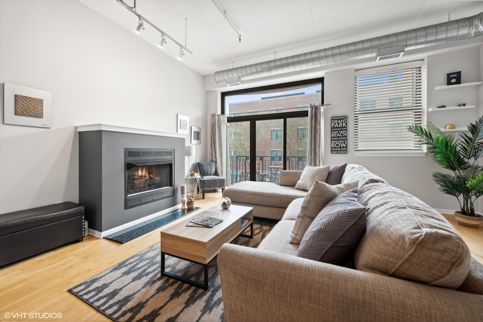 1301 West Madison Street, Unit 203 Chicago, IL 60607 - Photo 4 of 14 a living room with furniture and a fireplace