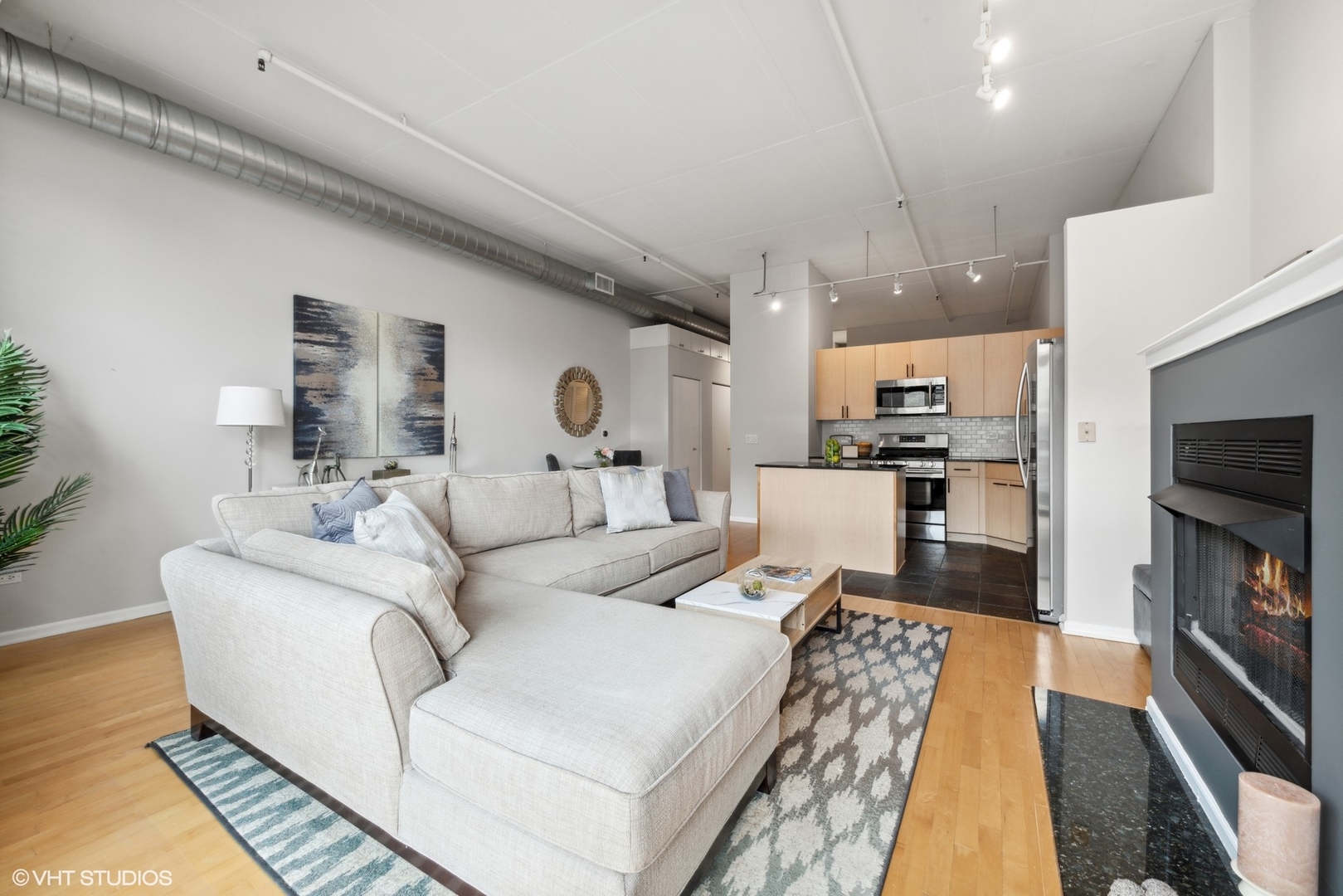 1301 West Madison Street, Unit 203 Chicago, IL 60607 - Photo 7 of 14 a living room with furniture and a flat screen tv