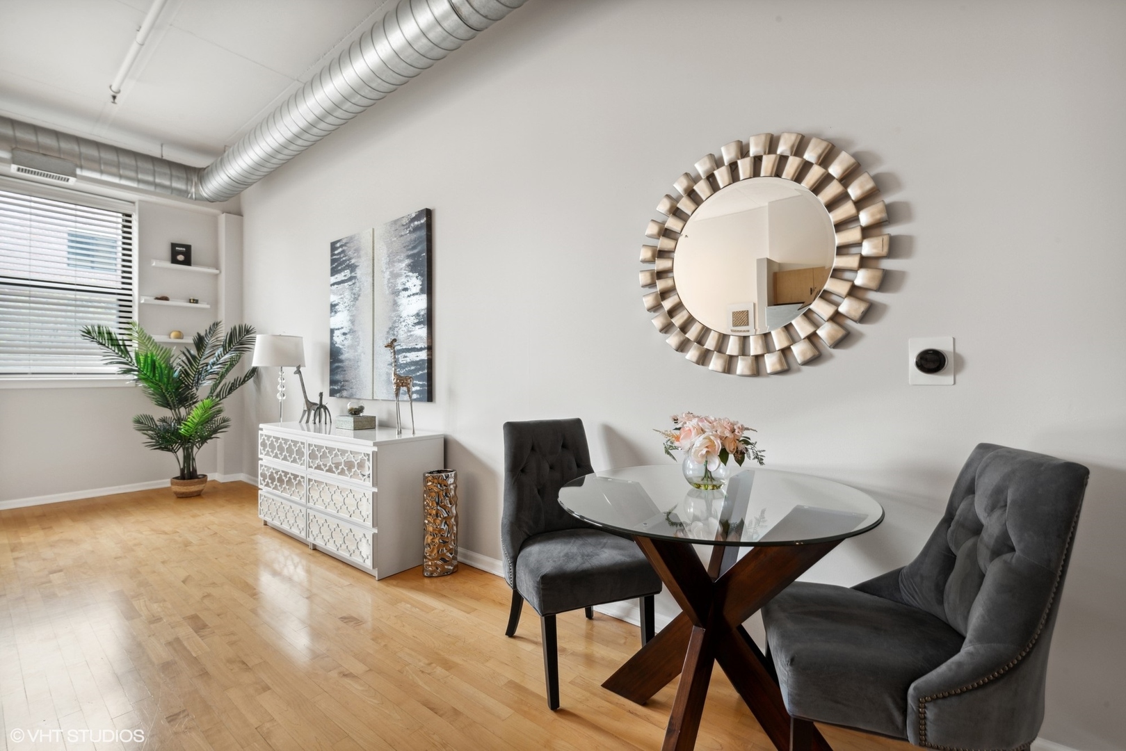 1301 West Madison Street, Unit 203 Chicago, IL 60607 - Photo 9 of 14 a view of a dining room with furniture and wooden floor