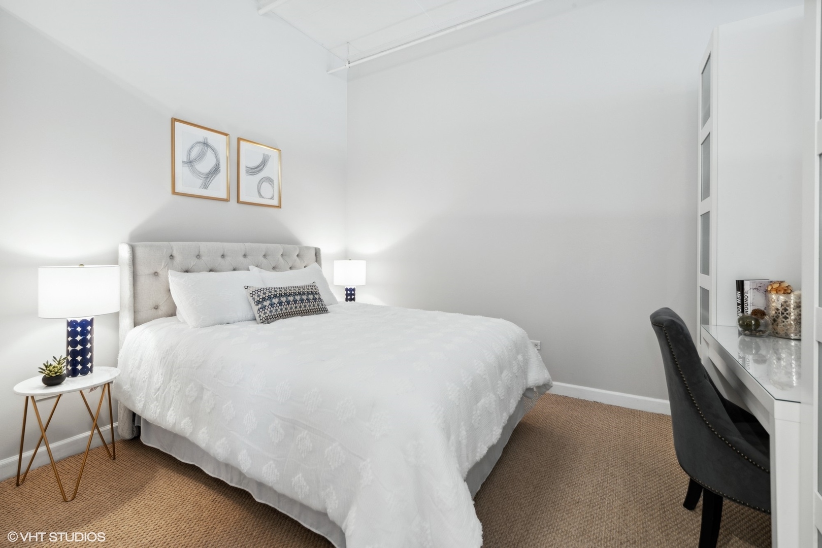 1301 West Madison Street, Unit 203 Chicago, IL 60607 - Photo 10 of 14 a bedroom with a bed and a chair