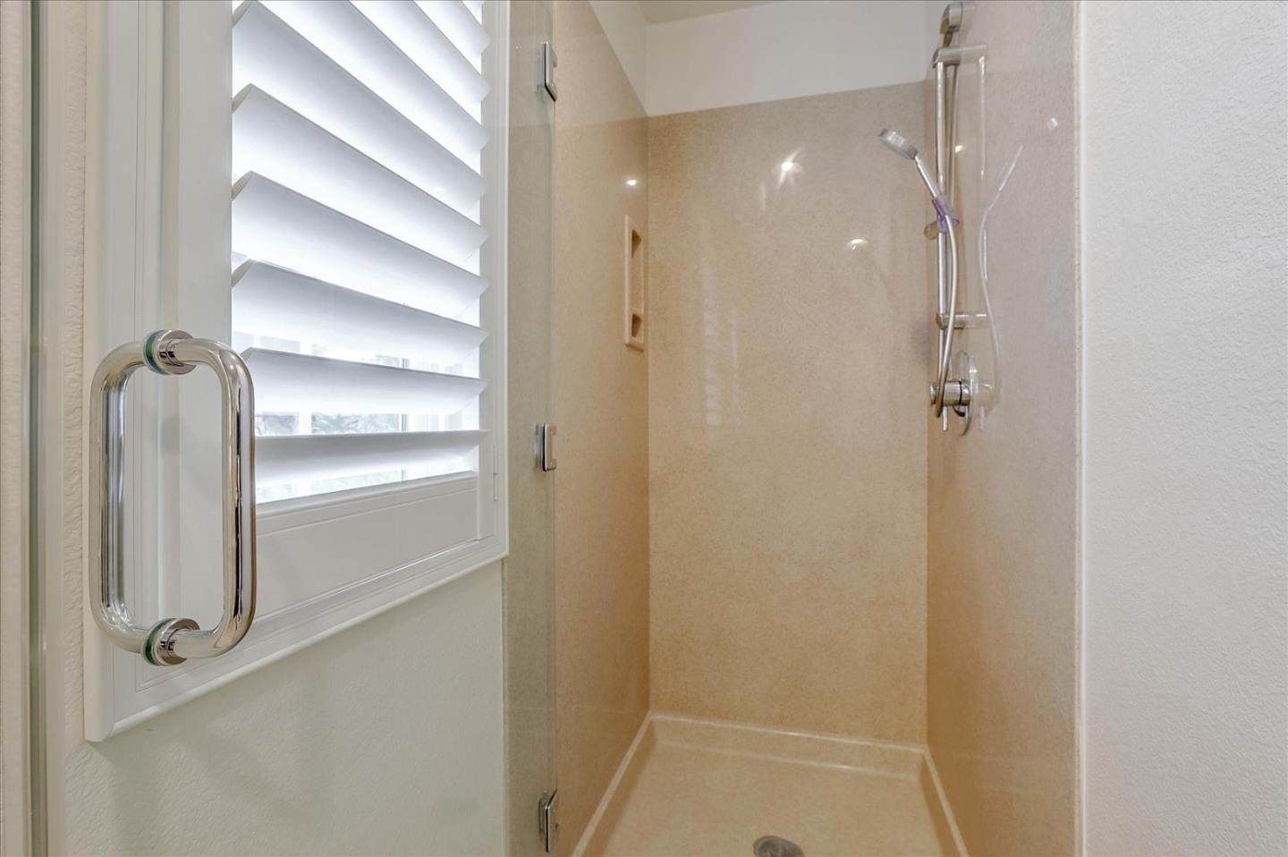 5803 Killarney Circle San Jose, CA 95138 - Photo 24 of 57 a bathroom with a glass shower door