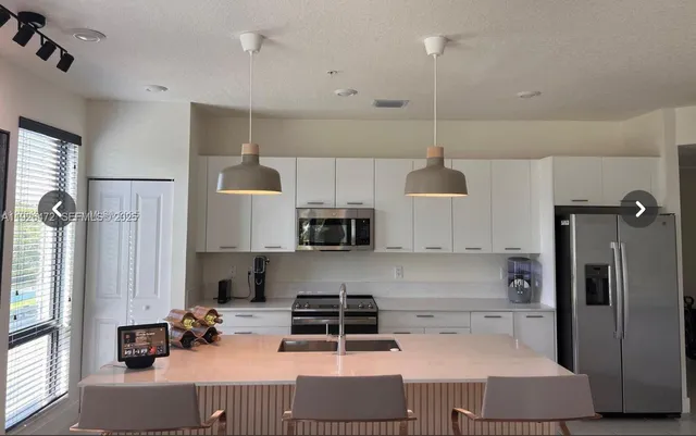 a view of a living room and kitchen floor