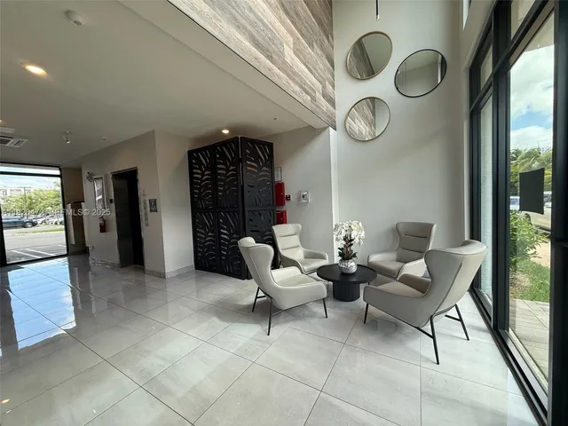 a view of a livingroom with furniture and white walls