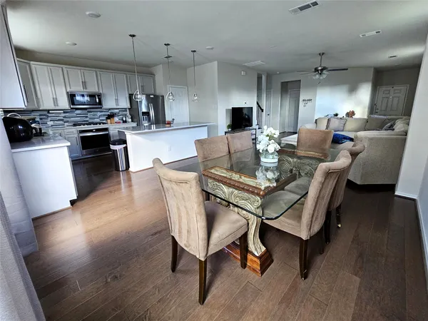 a view of a dining room with furniture and wooden floor