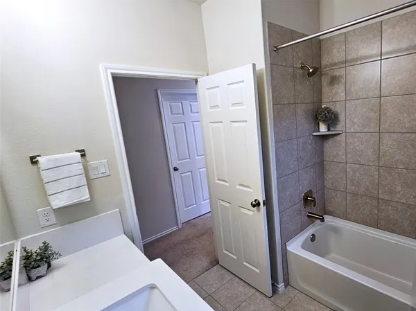 a bathroom with a bathtub a sink and a shower
