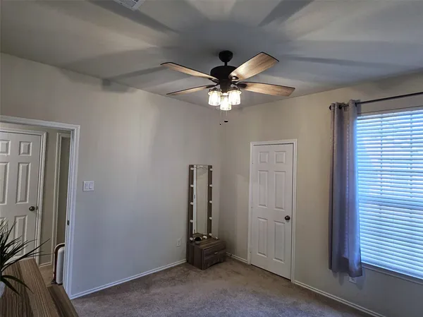 a view of a livingroom with a ceiling fan and window