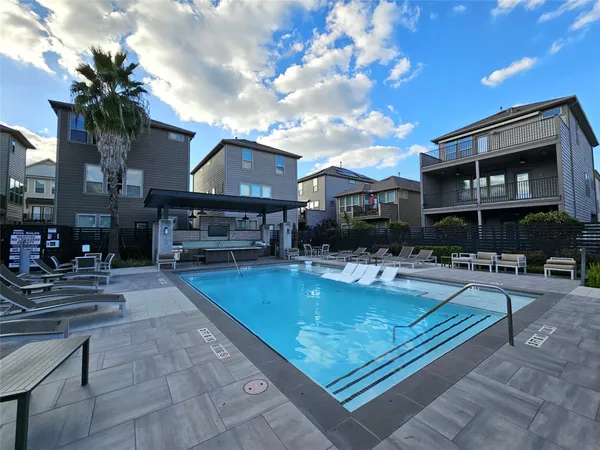 a view of a house with swimming pool and sitting area