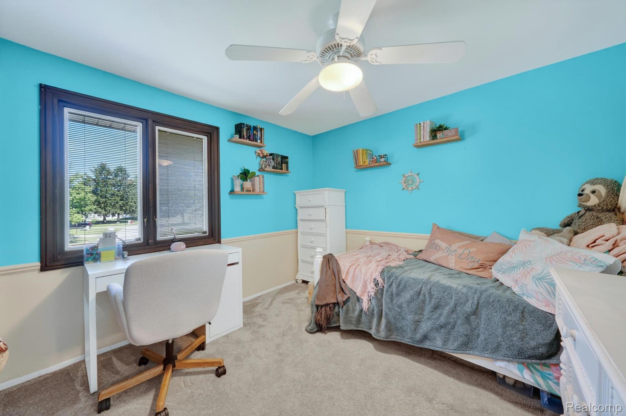 5469 Pheasant Run Road Clarkston, MI 48346 - Photo 24 of 36 Bedroom featuring vibrant blue walls, chair rail molding, and a brown window frame