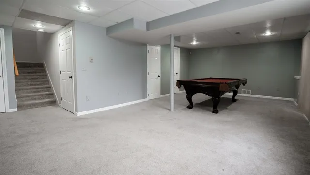 a view of a big room with wooden walls and stairs